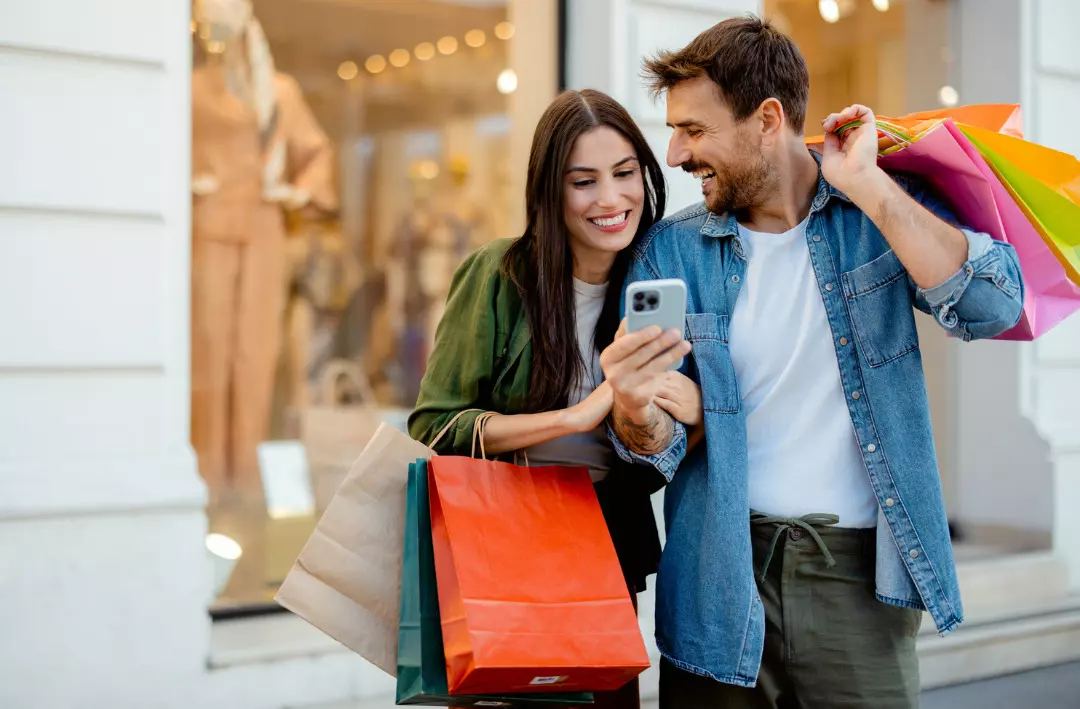 Couple shopping with colorful bags.