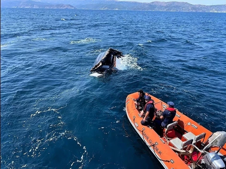 Whale breaching near rescue boat.