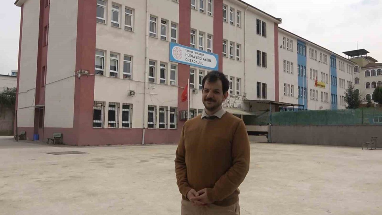 Man standing in school courtyard.